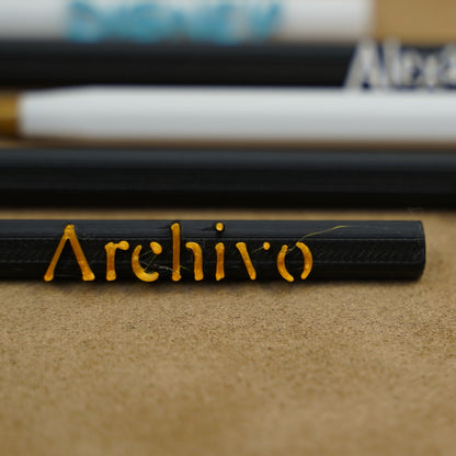 Close-up of personalized pens with names engraved, showcasing unique writing instruments in various colors.