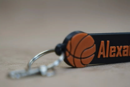 Personalised basketball keychain featuring a customizable design with a basketball emblem and name.