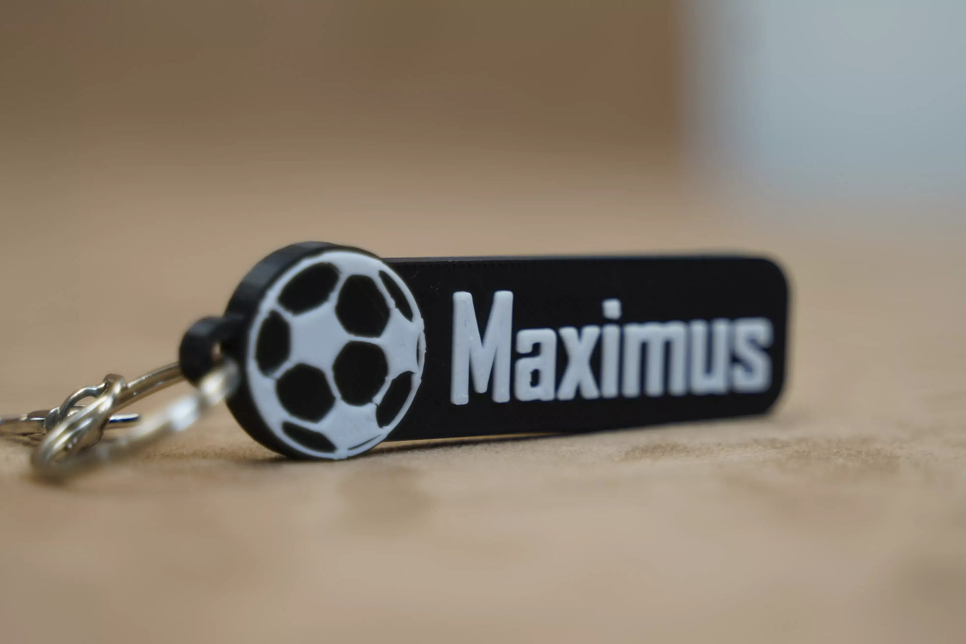 Personalised football keychain featuring the name "Maximus" and a soccer ball design, ideal for football fans.