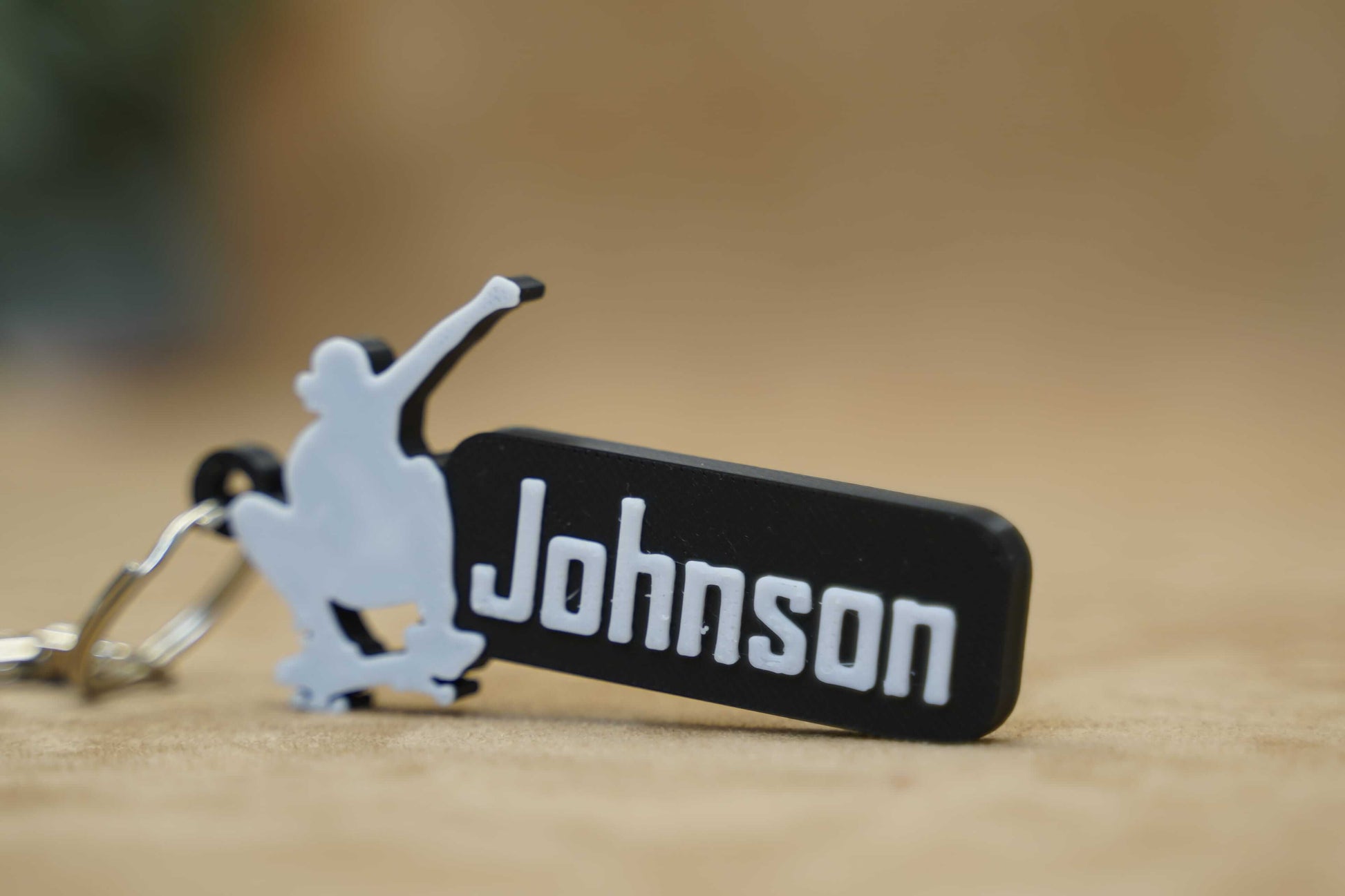 Personalised skater keychain featuring the name "Johnson" and a skateboarder silhouette for skateboarding enthusiasts.