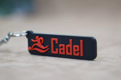 Personalised keychain with the name 'Cadel' and a running figure in red, perfect for sports enthusiasts.