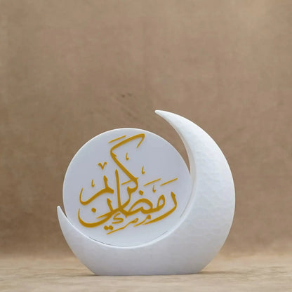 Elegant Ramadan decorative piece in a crescent moon shape, featuring gold Arabic calligraphy. Perfect for festive table decor.